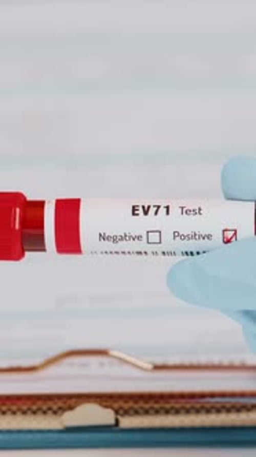 Close Up of Gloved Hand Holding Positive Test Vial
