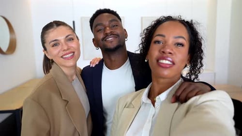 Smiling Colleagues Take a Selfie in the Workplace
