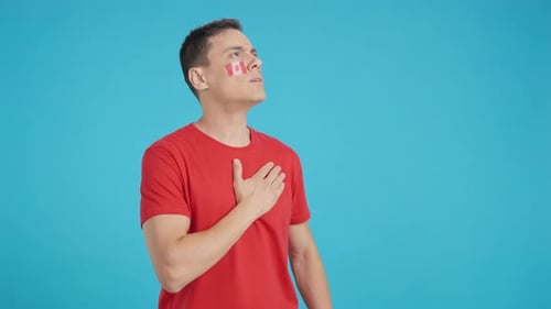 Man Listening to the Canada National Anthem with Solemnity