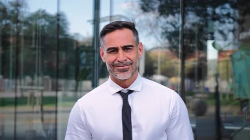 Close Up Portrait of Successful Mature Caucasian Business Man Smiling Looking at Camera Standing