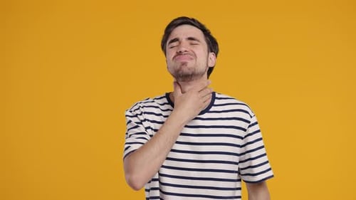 Young Man Has Sore Sick Guy With Swollen Throat On Yellow Studio Angina Pain
