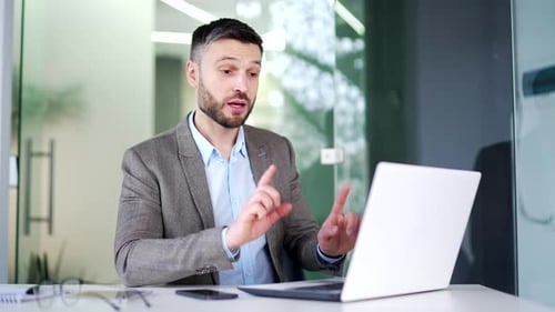 Professional Man Working on Laptop in Modern Office