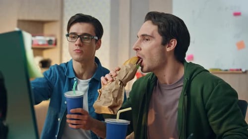 Office Guys Eating Sandwich Looking Monitor Close Up Active Workers Discussing