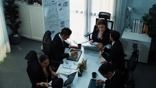 Top view of female leader looking financial statistic at meeting. Directorate.