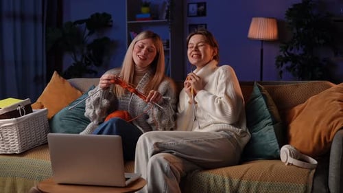 Women Knitting Together while Video Chatting at Home