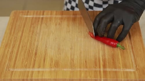 Dicing a Red Chili Pepper on Wood Cutting Board