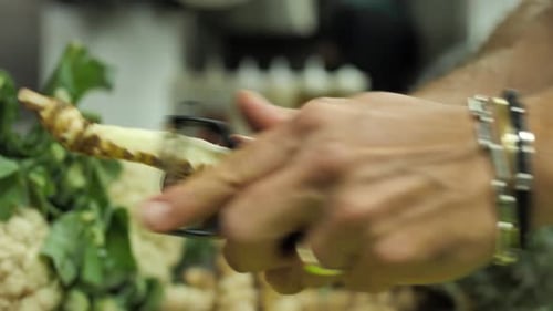 Man Peels Jerusalem Artichoke Root Vegetable Close Up