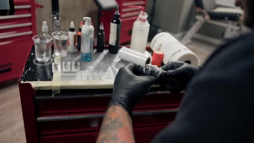 Tattoo Artist Prepares Equipment in Studio