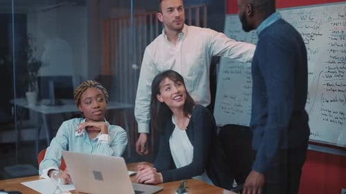 Three Young Attractive People in Business Clothes Working in Office and Looking at Laptop Screen Guy