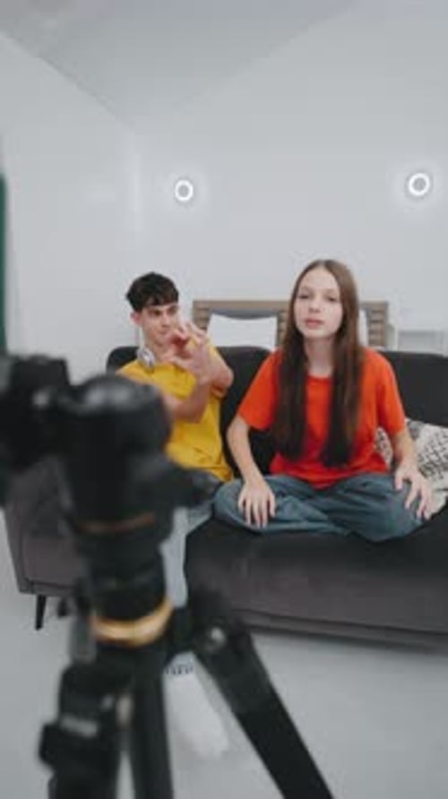 Two Teens Recording Video on Couch