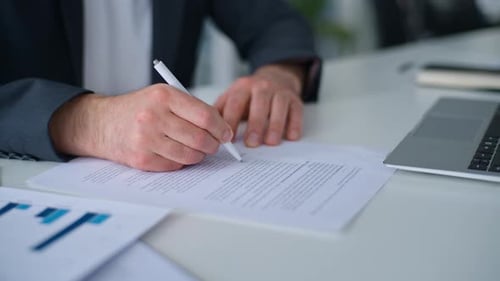 Close Up Male Hands Signing Business Paper Approved Loan Mortgage Trading Selling Contract at Table