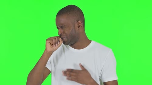 Portrait of Coughing African Man on Green Background