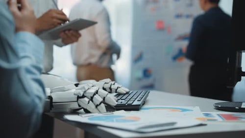 Robot Arm Typing at Keyboard in Office Meeting