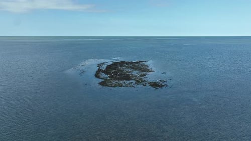 Aerial view of water and small island, Bernieres-sur-Mer, Normandy, France.