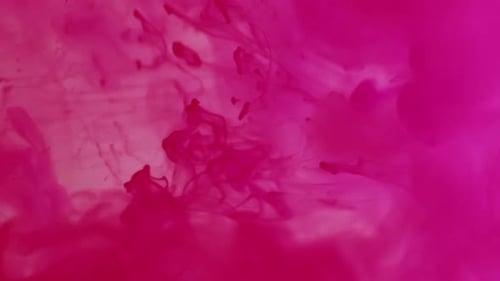 Pink Ink Cloud Spreading Slowly Underwater