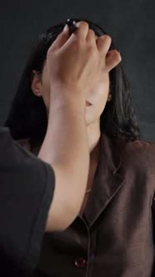 The Professional Makeup Application Process That Occurs in a Studio Setting with Precision