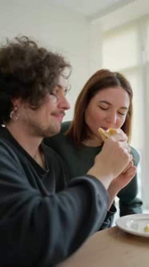 Couple Sharing a Pastry Together in Their Home