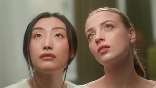 Stylish Women Posing with Delicate Flowers