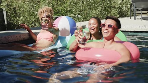 Diverse friends enjoy a sunny day at the pool