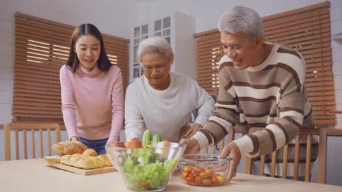 Three People Preparing Food in a Bright Kitchen