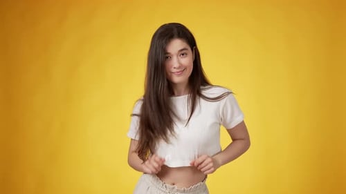 Stylish Woman Posing in Crop Top on Yellow