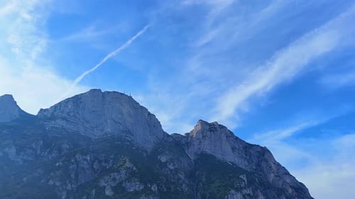 Majestic clouds gliding over towering mountain peaks