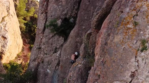 Climbing man in the mountain. Drone view of climber sportsmen.Physical activity in the countrysid