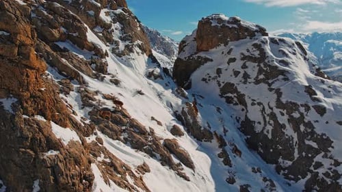 Snowy Rocky Mountain Goat Climbing