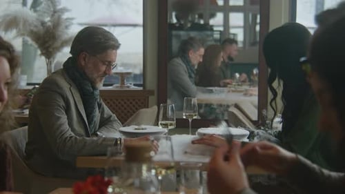 Man and Woman Sit in Molecular Cuisine Restaurant