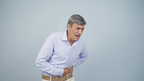Old man experiencing stomachache.