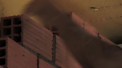 Bricklayer Building Interior Wall with Bricks and Cement