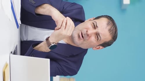Man Explaining Business Concept at Desk, Vertical Shot