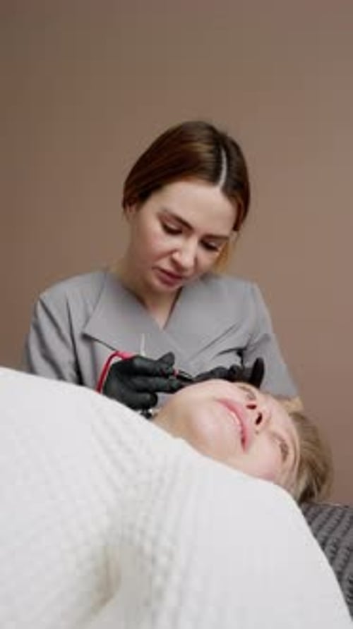Woman Receiving Facial Cosmetic Procedure at Home