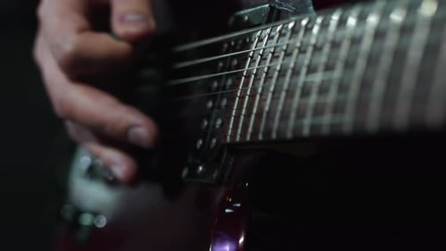 Musician Standing on a Stage with the Concert Lighting During the Show Start Playing Electric Guitar