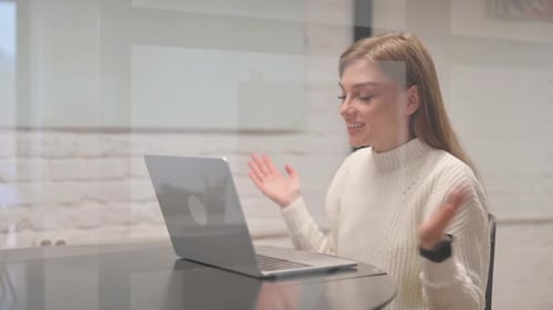 Woman on Laptop Attends Video Meeting in Office