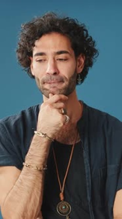 Pensive man thinking something, having good idea isolated on blue background in studio