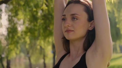 A young woman engaged in yoga in the garden. Happiness. A blurry background. Hipelly concept of life