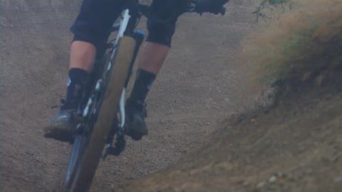 A mountain biker rails in a turn in slow motion