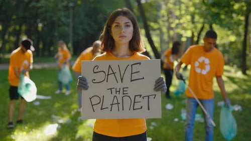 Young Woman Advocates for Clean Environment in Park