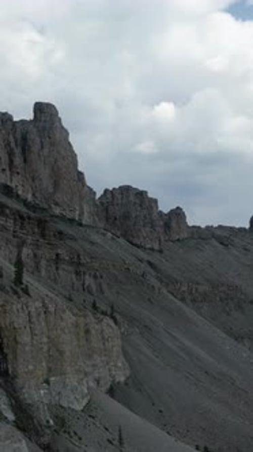 Rocky Mountain Range Under Cloudy Sky: A Vertical Video of Nature's Majesty