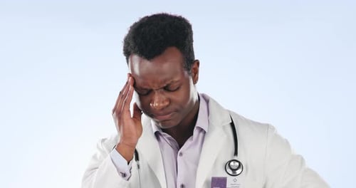 Black man, doctor and stress headache on studio background for healthcare mistake