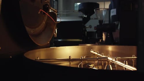 Coffee beans rotating inside industrial roasting machine