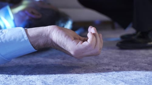 Investigator Examines Body at Crime Scene