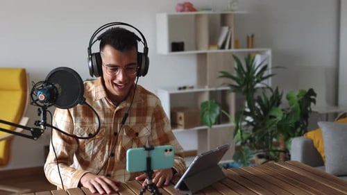 Young Adult Broadcasting with Microphone and Tablet