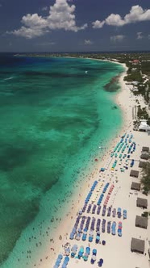 Vertical Aerial Descend Over Seven Mile Beach With Beachgoers