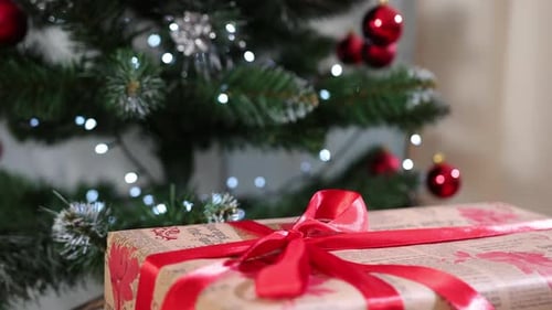 Beautiful Christmas Gift Boxes on Floor Near Fir Tree in Room Xmas Decorations