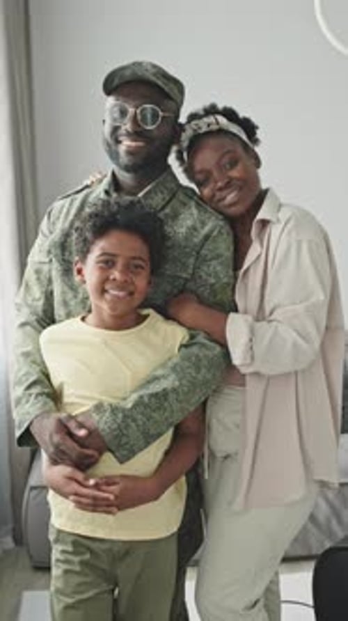 Smiling Family Poses Together in Their Home