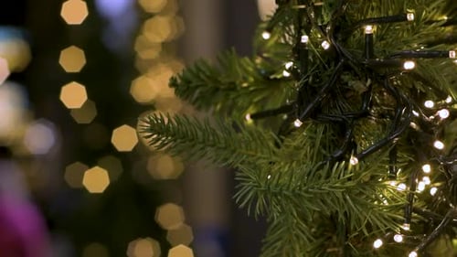 View of Christmas tree with LED lights and out-of-focus lights in the background. Bokeh lights.