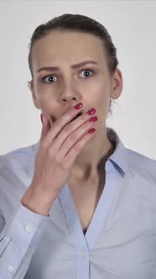 Woman Shocked with Hand Over Mouth in Studio