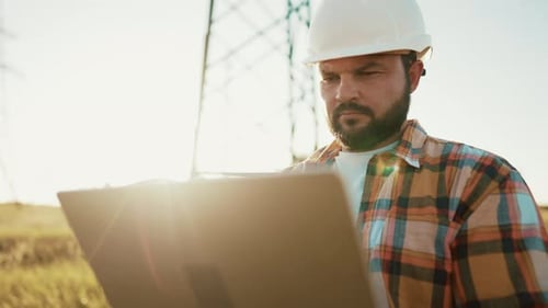 Male Engineer Using Laptop Computer to Online Work in Wheat Field Thinks and Rubs His Beard